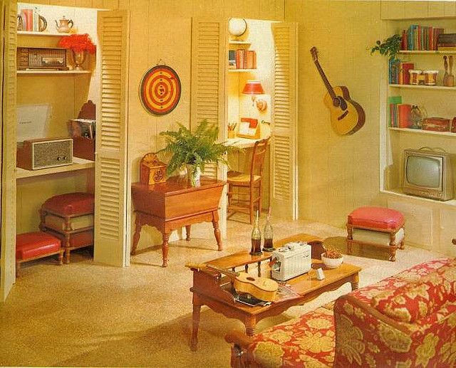 a living room filled with furniture and a guitar on the wall