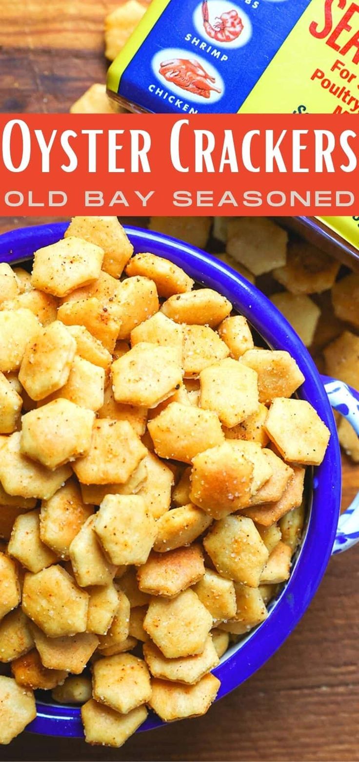 a blue bowl filled with cheesy oyster crackers next to a box of sea salt