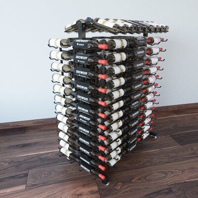 a stack of wine bottles sitting on top of a wooden floor