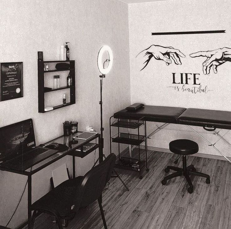 a black and white photo of a room with two desks