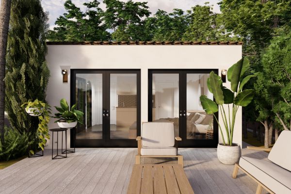 an outdoor patio with chairs, tables and potted plants on the wooden flooring