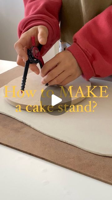 a person using a pair of scissors to make a cake