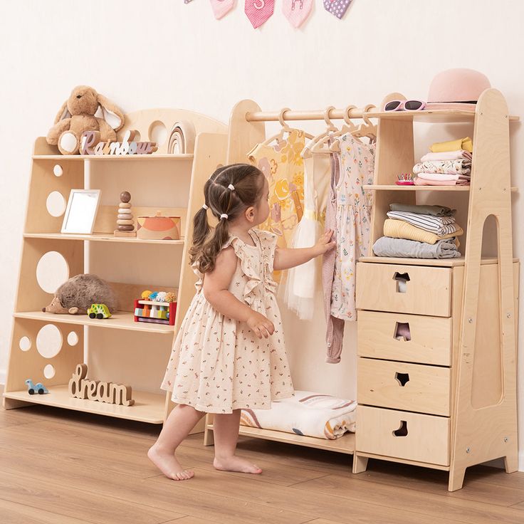 Introducing our beautifully crafted Montessori Dresser, a perfect addition to any children's bedroom. The closet is crafted to store kids' clothes, toys, and books, helping to keep their items easily reachable and promoting their independence. Its thoughtful design makes the dresser a valuable helper for parents as it features lots of shelves for preserving kids’ stuff. Benefits of Montessori Dresser for Kids’ Development Open wardrobes like the Montessori Dresser play a crucial role in a child' Children Closet Design, Montessori Room Design, Montisorri Bedroom Idea, Montessori Girl Bedroom, Montessori Clothes Storage, Colorful Montessori Bedroom, Ikea Montessori Bedroom, Montessori Bedroom Shelves, Montessori Bedroom Toddler Boys