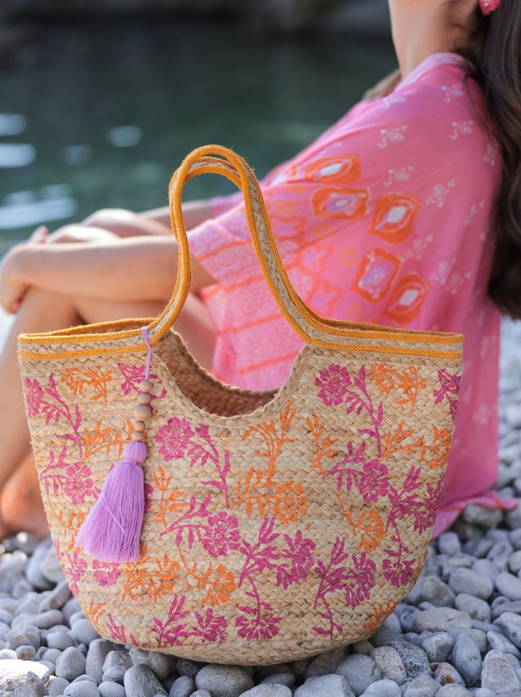 Update your summer collection with Shiraleah’s Graziella Tote. This bag features a floral design, double shoulder straps and a tassel as an accent detail. Its jute composition gives it the perfect summer aesthetic. Measuring L 19" x W 5.5" x H 17", the Graziella Tote is the perfect addition to any summer outfit. Pair with other items from the Shiraleah collection to complete your look! Color: Pink L 19" X W 12" X H 13"; Hnd 11" Material: Jute Double Handles Made In India Vegan 01-59-005 Pink Crochet Satchel Bag For Summer, Spring Beach Bag In Natural Color With Removable Pouch, Spring Beach Bag With Removable Pouch In Natural Color, Natural Beach Bag With Removable Pouch For Spring, Bohemian Bags For Spring Shopping, Bohemian Bags With Removable Pouch For Summer, Bohemian Summer Beach Bag With Removable Pouch, Summer Bohemian Beach Bag With Removable Pouch, Bohemian Beach Bag With Removable Pouch For Summer