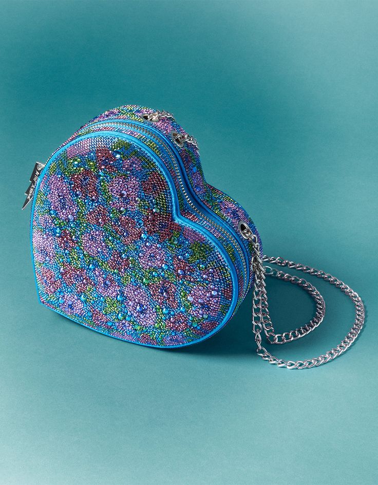 Fall in love with our STONE HEART CONVERTIBLE BAG! This rhinestone floral crossbody bag is shaped like a heart, adding a touch of romance to any outfit. Perfect for a night out or everyday use, it's a unique and playful accessory. Manmade materials with stones Convertible shoulder to crossbody strap 7.55"L x 2.25"D x 7.09"H Imported Unusual Handbags, Betsy Johnson Bags, Rhinestone Bag, Heart Purse, Betsey Johnson Purses, Happy Stuff, Embroidery Hearts, Embroidered Handbag, Second Account