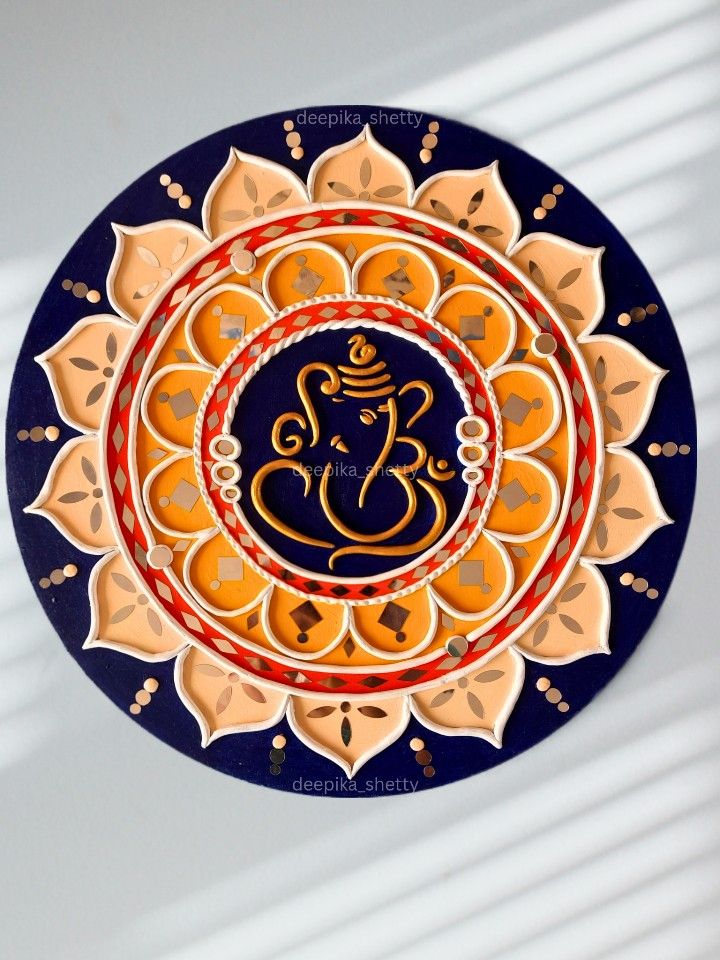 a decorative plate with an image of a ganeshi on it's side