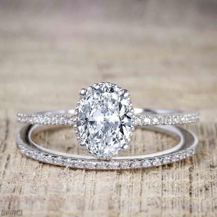 a close up of a ring with a diamond on the side and a wedding band