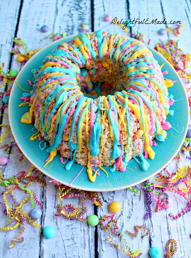 a bundt cake covered in sprinkles on a blue plate