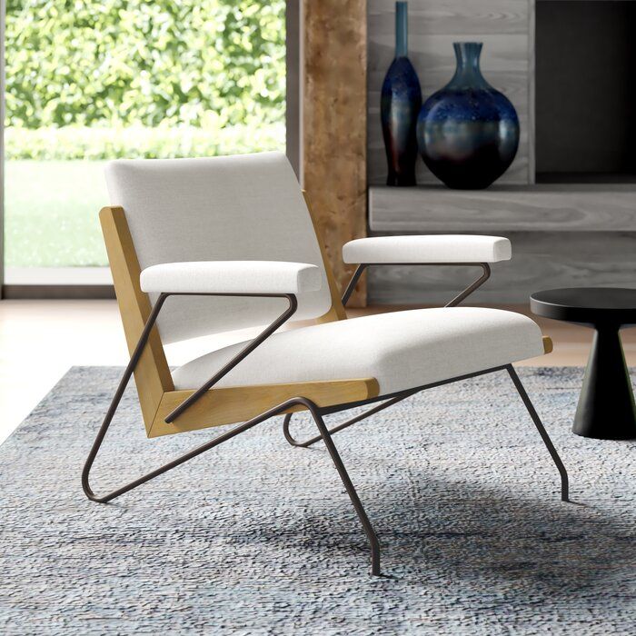 a white chair sitting on top of a rug in front of a black coffee table