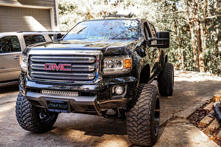 a black truck parked in front of a house