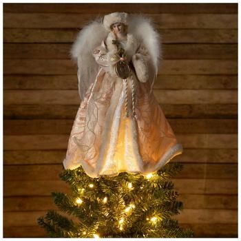 an angel figurine sitting on top of a christmas tree with lights around it