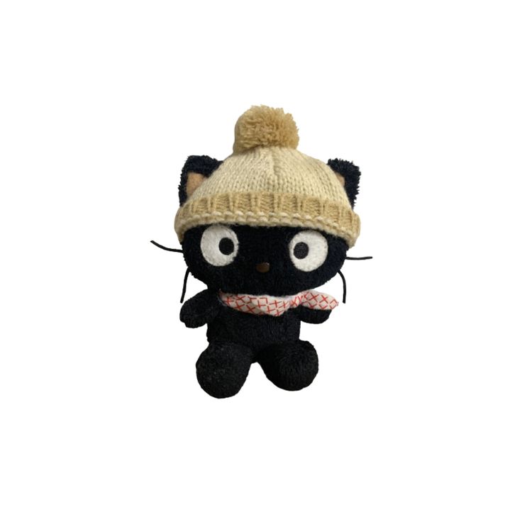 a black and white stuffed animal wearing a knitted hat