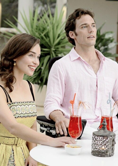 a man and woman sitting at a table with drinks