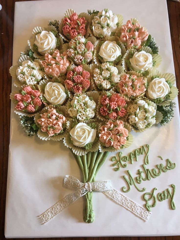 a bouquet of flowers sitting on top of a table next to a happy mother's day message