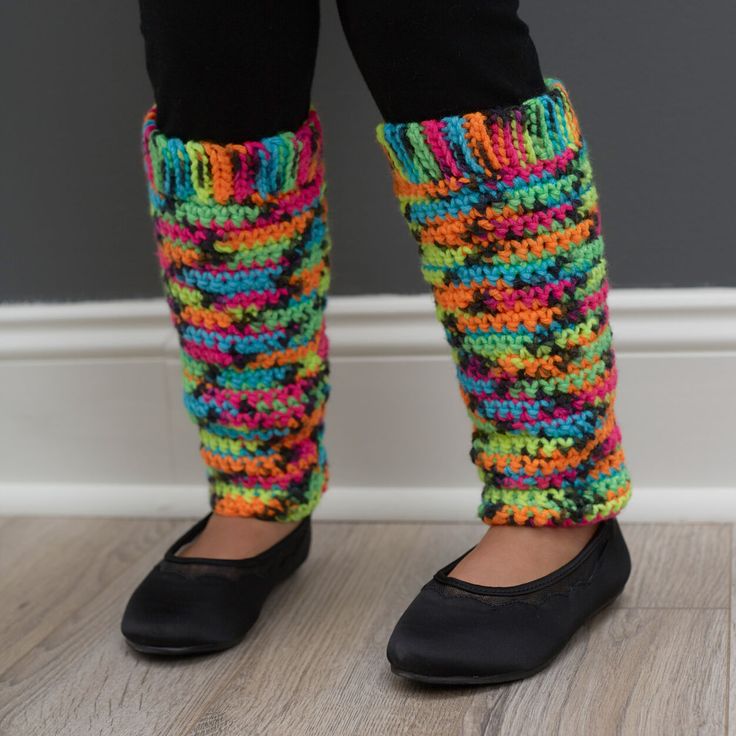 the legs of a person wearing black shoes with colorful socks and leg warmers on