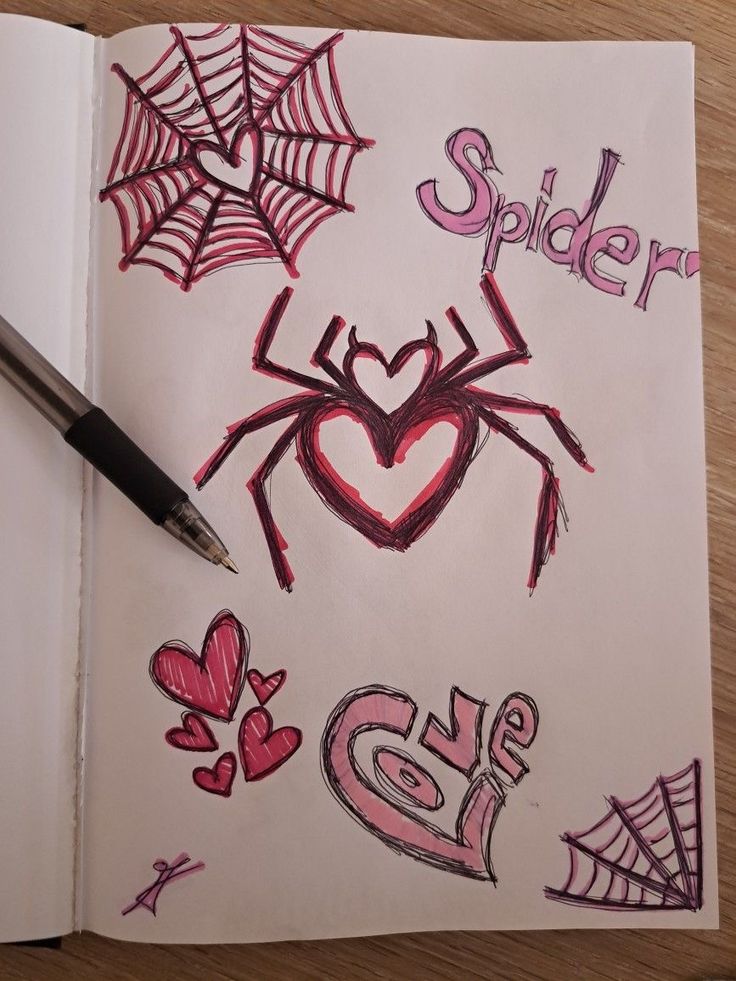 a notebook with spider drawn on it next to a pen and drawing the word love