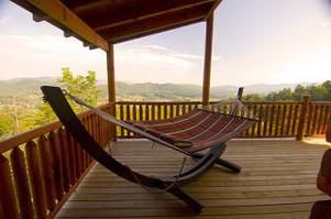 a hammock sitting on top of a wooden deck