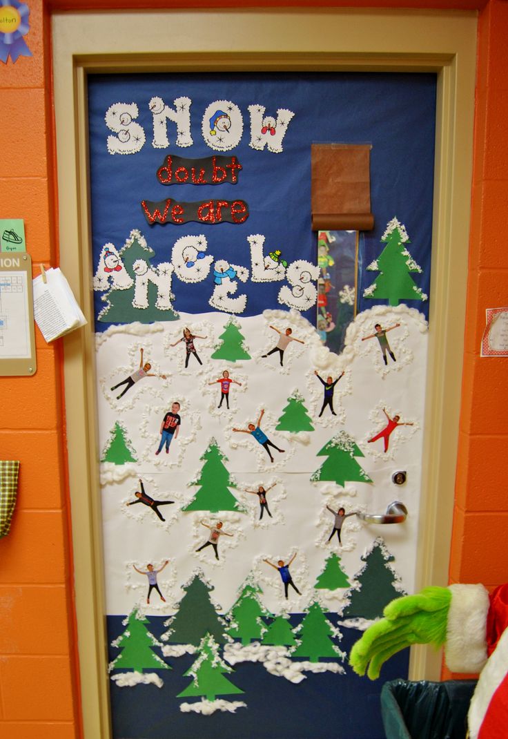 a door decorated with snow skiers and trees for the winter holiday season in an elementary classroom