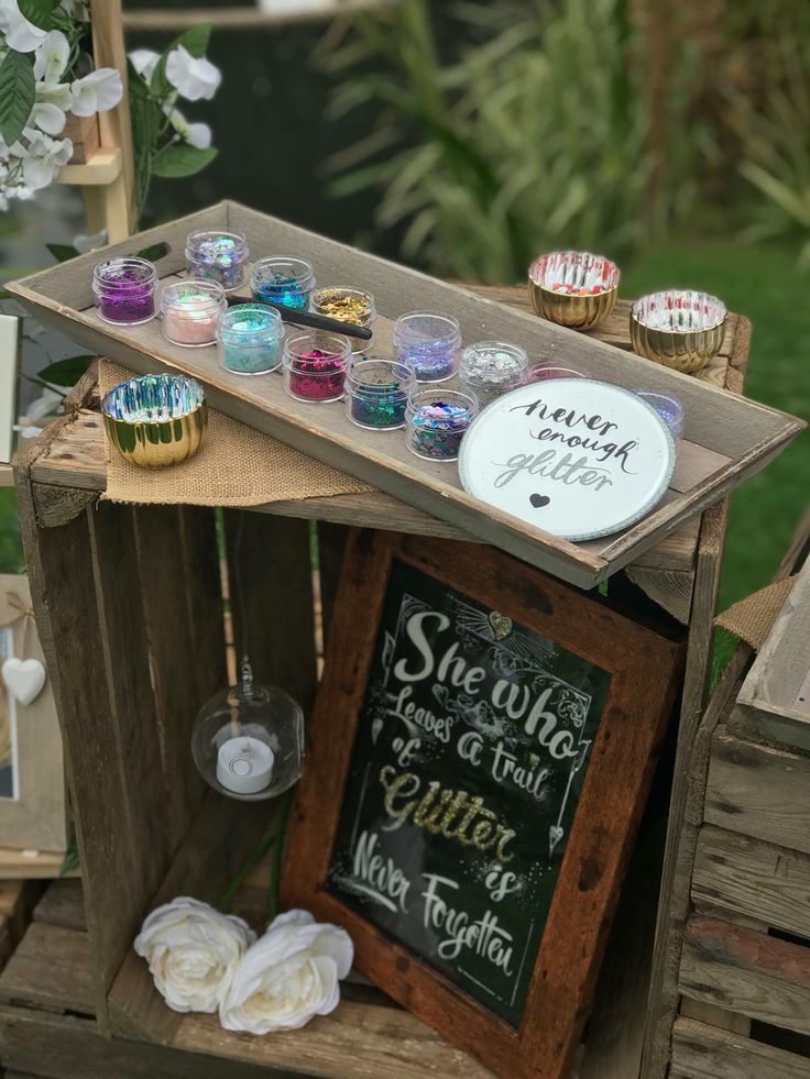 a wooden crate filled with lots of different types of candles and other things on top of it