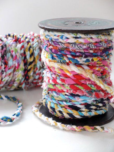 spools of multicolored thread on a white surface