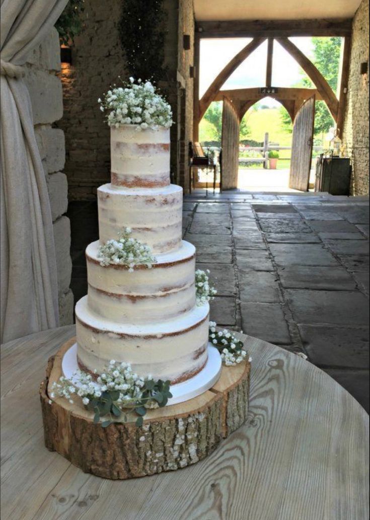 a wedding cake sitting on top of a wooden table