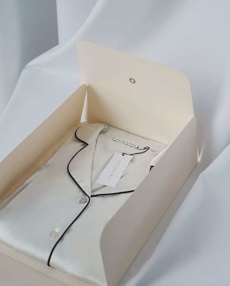 an open box with a white shirt in it