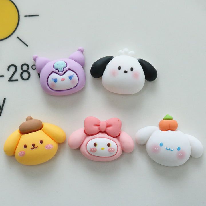 four different shaped erasers sitting on top of a white surface next to a clock