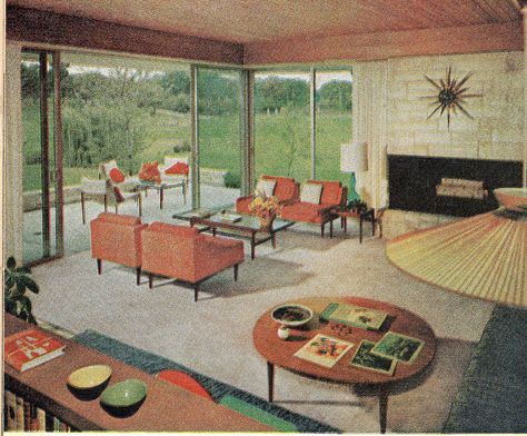 an old photo of a living room with orange furniture and large glass doors to the outside