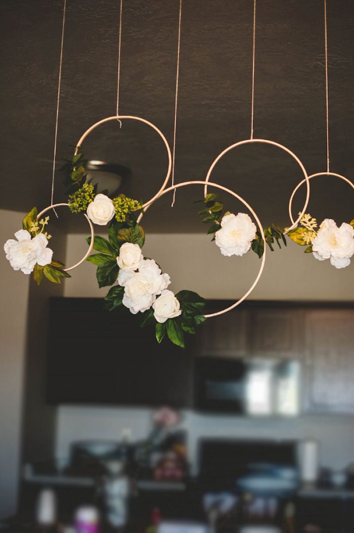 flowers hanging from the ceiling with text overlay that reads diy these floral hoop wreaths