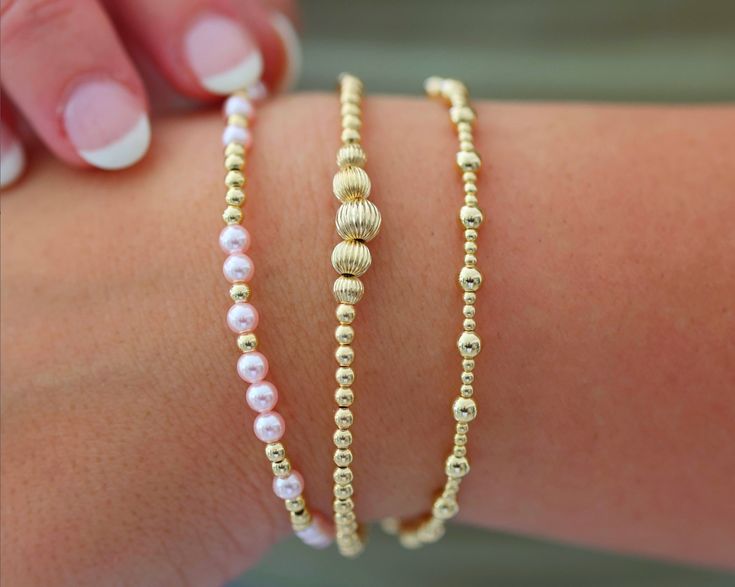 Waterproof | Tarnish Free | Hypoallergenic Bracelets: MELANIE ($49)- VICTORIA ($56)- ANGELINA ($46) Bead Material: Gold filled STRETCHY LENGTH: 6.5" OR 7" CLASP LENGTH: 6" + 1.5" EXTENSION High Performance Elastic Made in miami, made with love This stack is your ultimate accessory for effortless elegance and coastal chic. Inspired by the breezy sophistication of the Hamptons, these bracelets feature a collection of beautifully crafted ball beads in various sizes and colors, reminiscent of sun-ki Bracelets Stack, Gold Bracelets Stacked, Stack Bracelets, Preppy Bracelets, Preppy Jewelry, Coastal Charm, Jewelry Accessories Ideas, Rose Gold Pendant, Coastal Chic