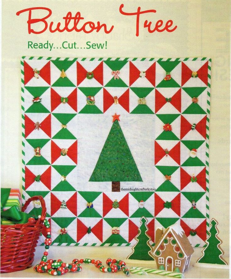 a quilted christmas tree with red and green triangles on it, surrounded by gingerbreads