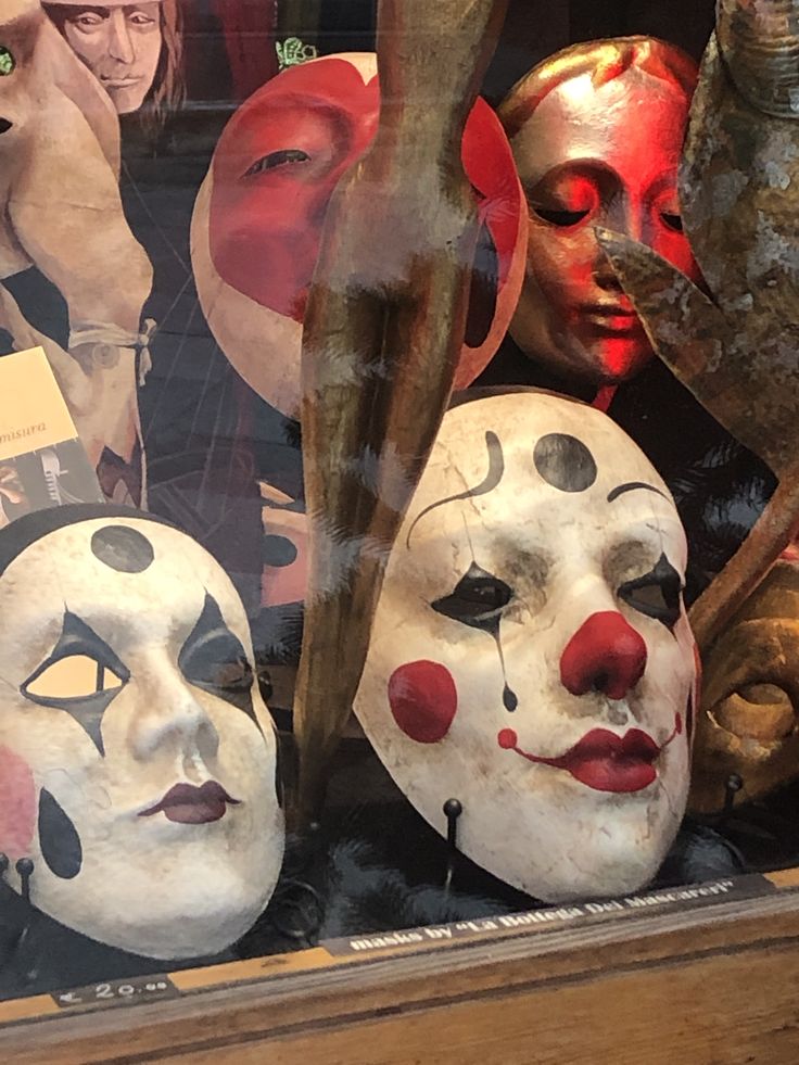 several masks are on display in a glass case