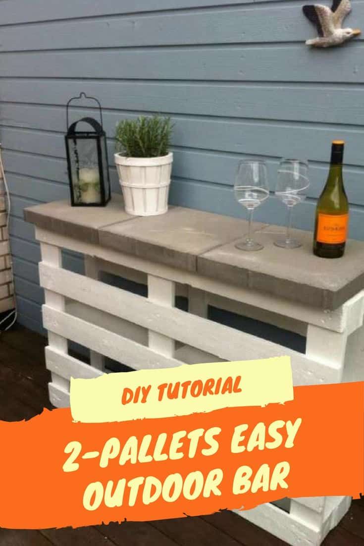 an outdoor bar made out of pallets with wine glasses and bottles on the table