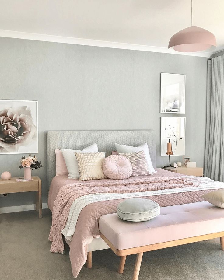 a bedroom with pink and white decor in it