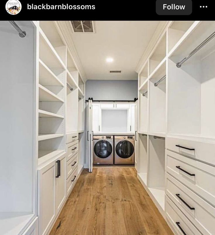 an empty laundry room with white cabinets and wood floors