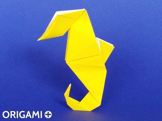 an origami bird on a blue background with the word origami below it