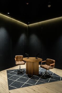 an empty conference room with chairs and a round table in the center, lit by dim lighting