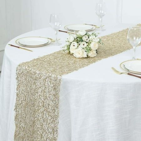 the table is set with white flowers and gold sequins for an elegant touch