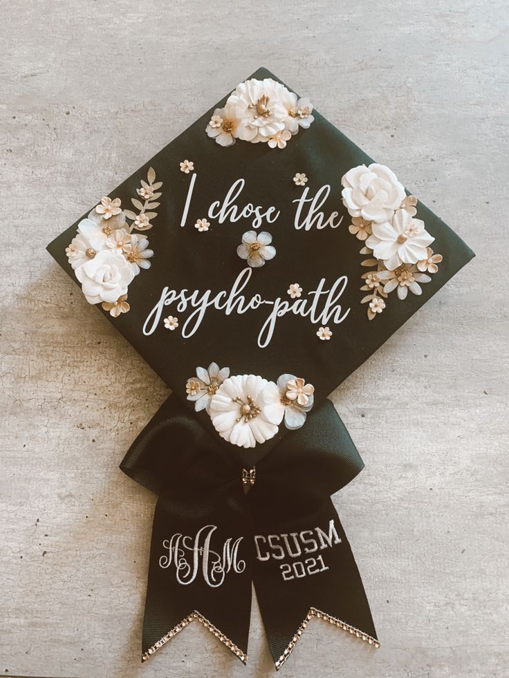 a black graduation cap with white flowers and the words, i chose the joyful faith