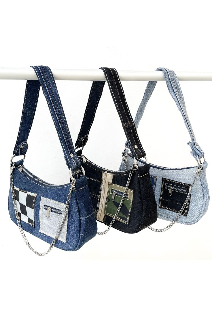 three purses hanging from a clothes line on a white background with no people around them