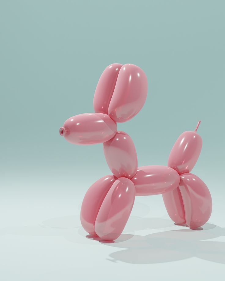 a pink balloon dog sitting on top of a table