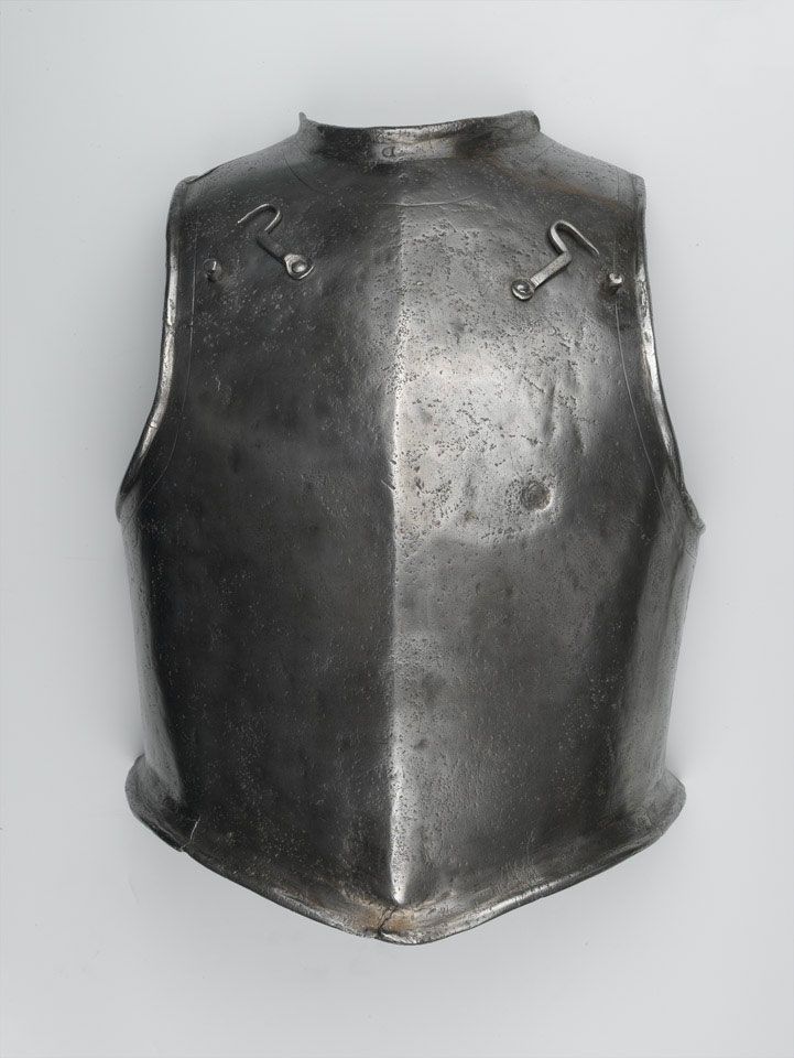 an old metal armor is displayed on a white background with clippings to the side