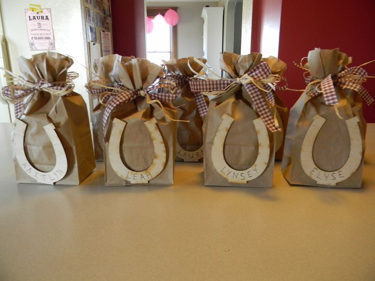 four brown bags with burlocks tied to them sitting on a counter in front of a door