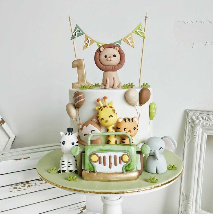 a birthday cake decorated with animals and decorations