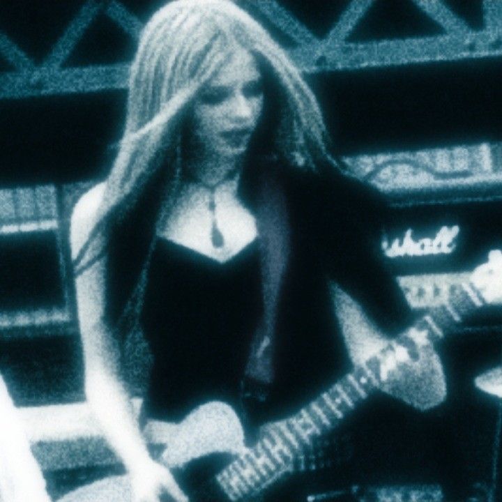 a woman with long hair playing a guitar