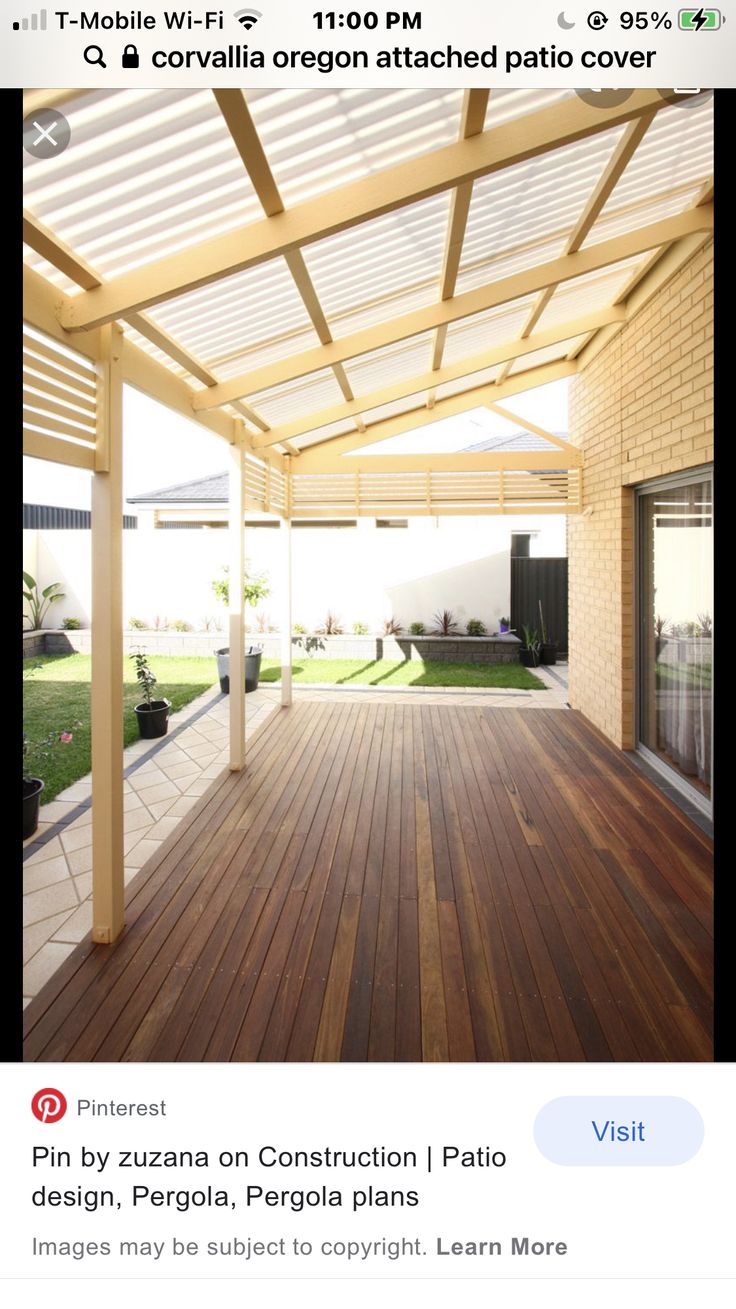 an outdoor covered patio area with wooden flooring