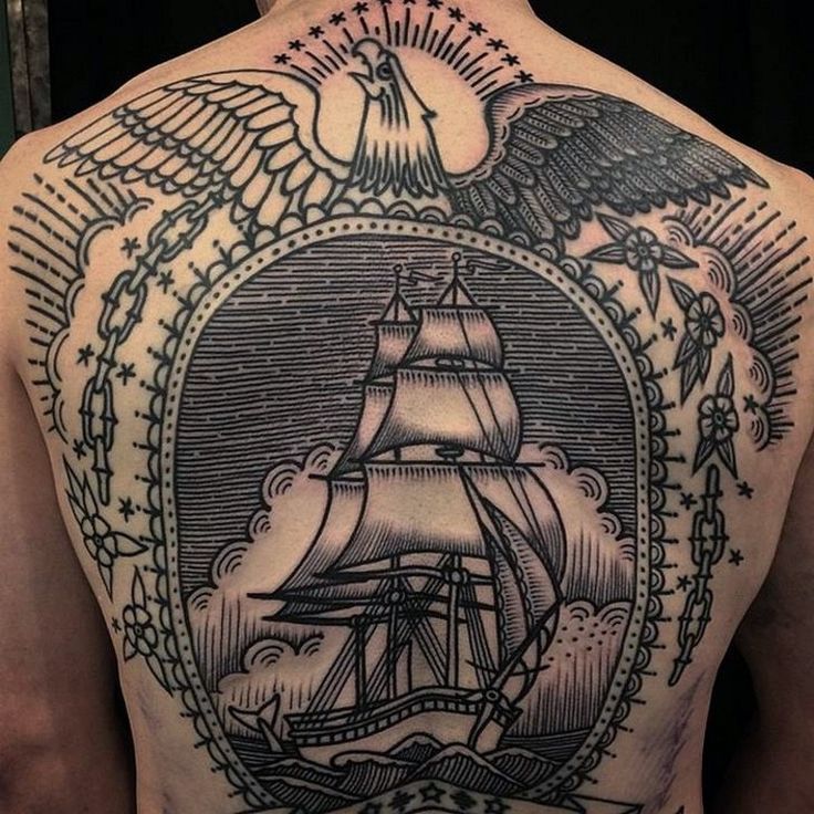 the back of a man's upper half with an eagle and ship on it