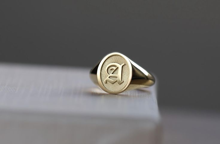 initial engraved oval signet ring ♡  material options: we offer solid gold and 925 sterling silver as materials; 10k gold 14k gold 14k rose gold 14k white gold 925 sterling silver (plain) oxidized 925 sterling silver ( backround of letter will be oxidized ) 14k gold plated over silver 14k rose gold plated over silver please check last image for font options  ♡ the ring has hollow back ♡ ring face: 10 x 12 mm size: we offer sizes from 3 to 13 1/2 for bigger size requests, please send a message ♡ important note about the ring size:   ♡ to be able to make a ring which fits perfectly we kindly ask you to double check your finger size as shown in the picture in our gallery before placing your order shipping: ♡ all our listings include free expedited shipping delivers in 2-4 business days care t Oval 14k Gold Signet Ring With Initials, 14k Gold Oval Initial Ring, Oval Initial Ring In 14k Gold, Fine Jewelry Oval Signet Ring With Initials, Gold Oval Initial Ring With Engraving Option, Gold Sterling Silver Signet Ring With Hallmarks, Yellow Gold Oval Initial Ring In Sterling Silver, Oval Initial Ring In 14k Gold For Gift, Yellow Gold Oval Initial Ring