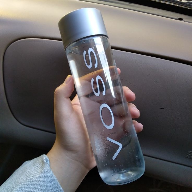 a person holding a water bottle in their hand with the word slow written on it