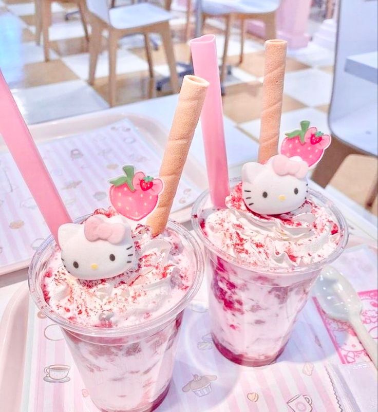 two hello kitty drinks with strawberries on top